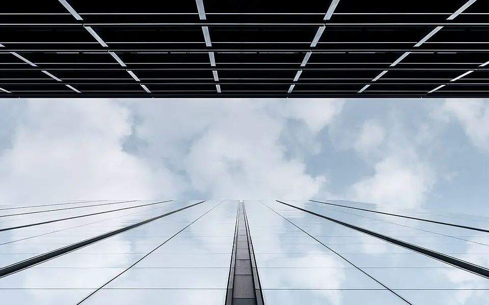 Commercial glass tower reflecting the sky